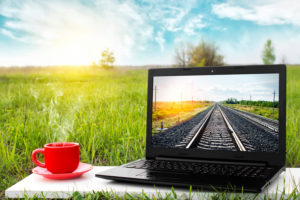 Laptop and cup of hot coffee